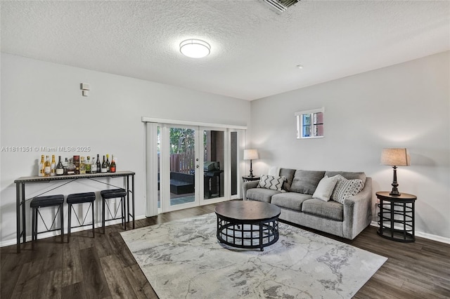 1001 NW 100th Ave, Pembroke Pines, FL 33024 - living area with wood finished floors, baseboards, a textured ceiling, and french doors