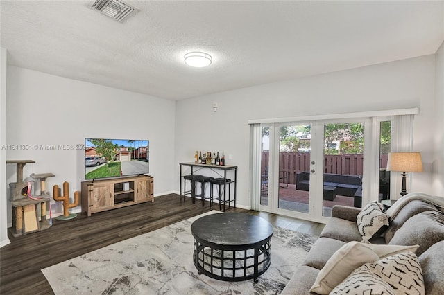 1001 NW 100th Ave, Pembroke Pines, FL 33024 - living area with french doors, wood finished floors, a textured ceiling, and baseboards