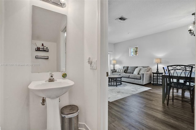 1001 NW 100th Ave, Pembroke Pines, FL 33024 - bathroom featuring wood finished floors, a textured ceiling, and baseboards