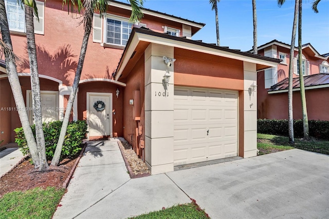 1001 NW 100th Ave, Pembroke Pines, FL 33024 - townhome / multi-family property featuring an attached garage, stucco siding, and concrete driveway