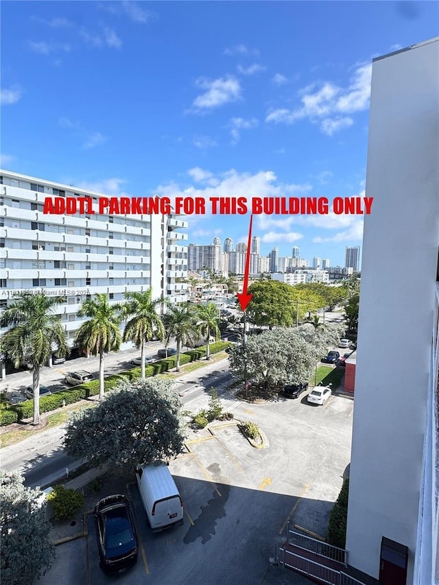 3660 NE 166th St Unit 603, North Miami Beach, FL 33160 - view of property with a skyline view and uncovered parking