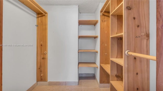 3660 NE 166th St Unit 603, North Miami Beach, FL 33160 - spacious closet featuring light tile patterned floors