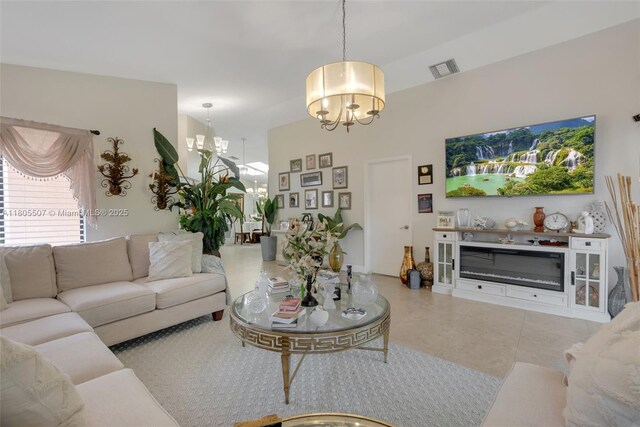 3831 NW 21st St, Coconut Creek, FL 33066 - living room with a chandelier, tile patterned flooring, and a glass covered fireplace