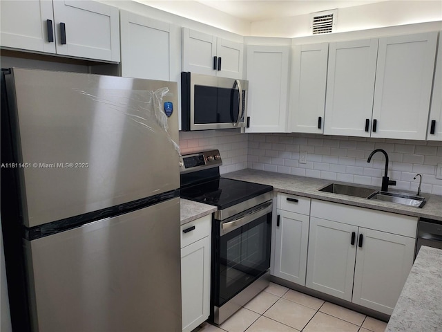 800 SW 131st Ave Unit 113F, Pembroke Pines, FL 33027 - kitchen featuring stainless steel appliances, a sink, backsplash, and light tile patterned floors