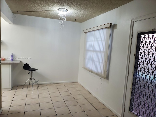 800 SW 131st Ave Unit 113F, Pembroke Pines, FL 33027 - unfurnished dining area featuring a textured ceiling and baseboards
