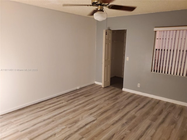 800 SW 131st Ave Unit 113F, Pembroke Pines, FL 33027 - spare room featuring ceiling fan, wood finished floors, baseboards, and a textured ceiling