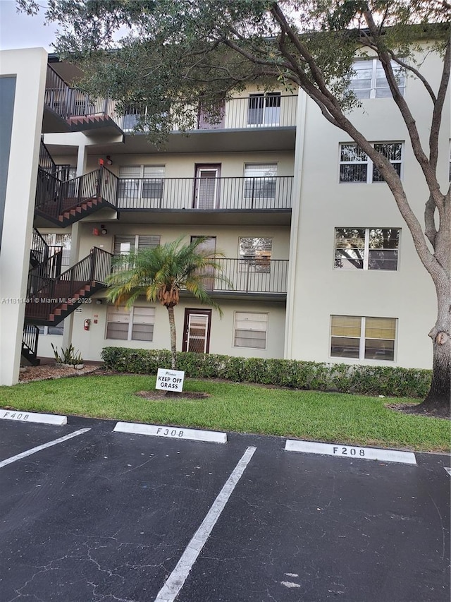 800 SW 131st Ave Unit 113F, Pembroke Pines, FL 33027 - view of building exterior featuring uncovered parking and stairs