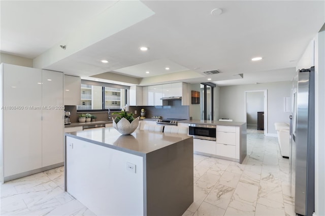 812 N Ocean Blvd Unit 405, Pompano Beach, FL 33062 - kitchen featuring modern cabinets, a center island, appliances with stainless steel finishes, white cabinetry, and recessed lighting