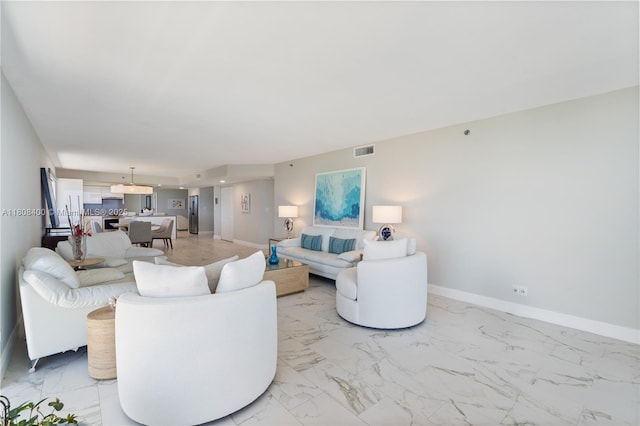 812 N Ocean Blvd Unit 405, Pompano Beach, FL 33062 - living area featuring light marble finish floors and baseboards