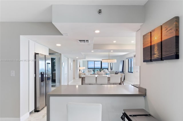 812 N Ocean Blvd Unit 405, Pompano Beach, FL 33062 - kitchen featuring stainless steel fridge with ice dispenser, white cabinets, a peninsula, recessed lighting, and modern cabinets