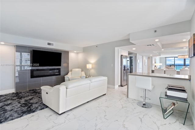 812 N Ocean Blvd Unit 405, Pompano Beach, FL 33062 - living room featuring light marble finish floors, baseboards, and recessed lighting