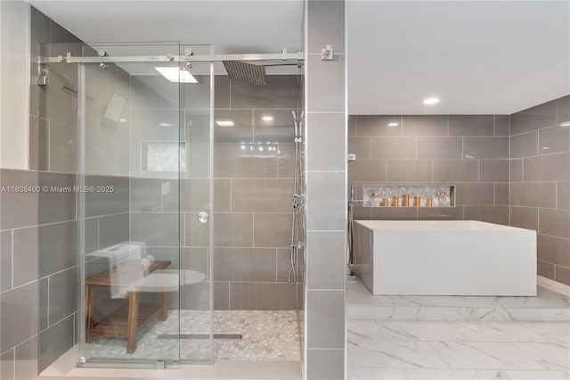 812 N Ocean Blvd Unit 405, Pompano Beach, FL 33062 - full bath with a stall shower, a soaking tub, tile walls, marble look tile flooring, and recessed lighting