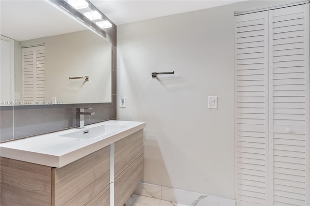 812 N Ocean Blvd Unit 405, Pompano Beach, FL 33062 - bathroom featuring a closet, vanity, marble look tile flooring, and baseboards