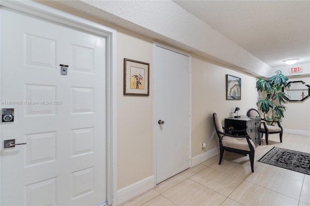 812 N Ocean Blvd Unit 405, Pompano Beach, FL 33062 - foyer entrance featuring baseboards, light tile patterned floors, and a textured ceiling