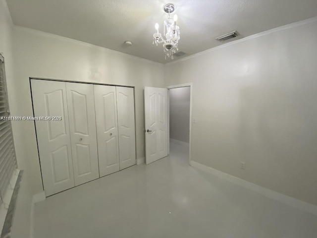 1371 NE 42nd Ave, Homestead, FL 33033 - unfurnished bedroom featuring a chandelier, crown molding, a closet, and finished concrete flooring