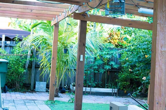 1371 NE 42nd Ave, Homestead, FL 33033 - fenced backyard with a patio and a pergola