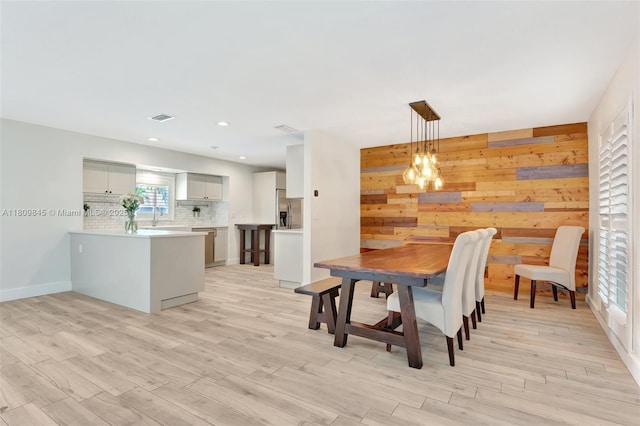 651 E Lake Dasha Dr, Plantation, FL 33324 - dining room featuring light wood-type flooring, wood walls, recessed lighting, and baseboards