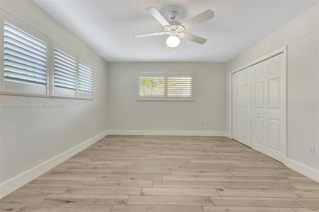 651 E Lake Dasha Dr, Plantation, FL 33324 - unfurnished bedroom with light wood-type flooring, baseboards, a closet, and a ceiling fan