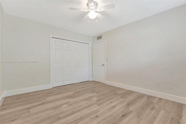 651 E Lake Dasha Dr, Plantation, FL 33324 - unfurnished bedroom featuring light wood-style floors, baseboards, and a closet