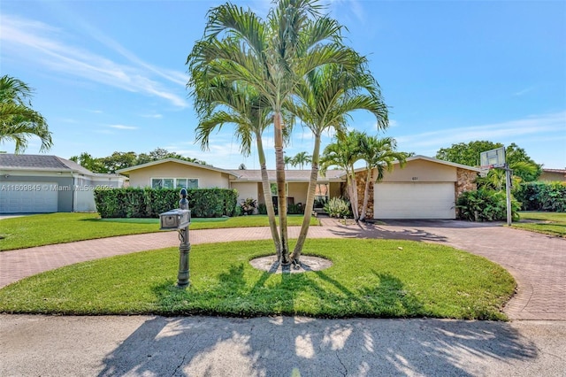 651 E Lake Dasha Dr, Plantation, FL 33324 - single story home with curved driveway, a front lawn, stucco siding, and a garage