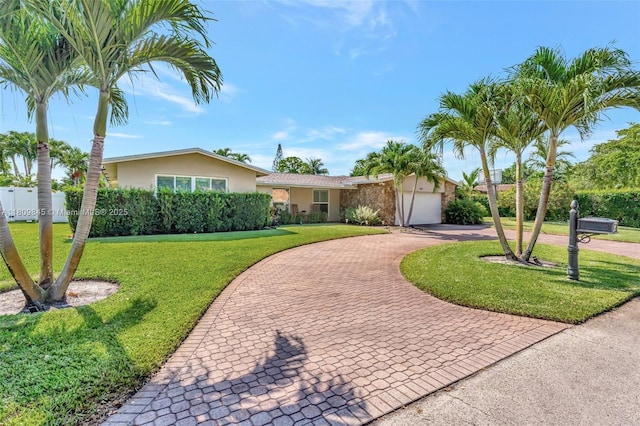 651 E Lake Dasha Dr, Plantation, FL 33324 - ranch-style home featuring curved driveway, stucco siding, and an attached garage