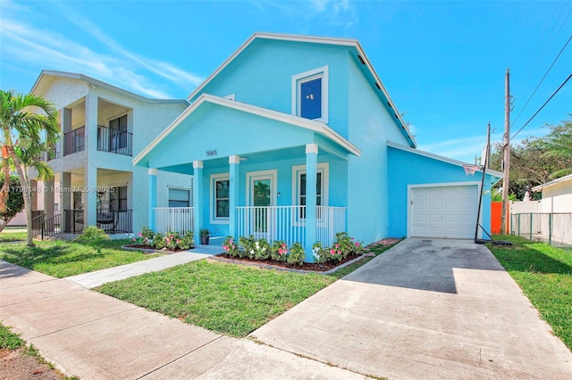 5565 SW 43rd St, Davie, FL 33314 - view of front of house featuring covered porch, concrete driveway, an attached garage, and stucco siding