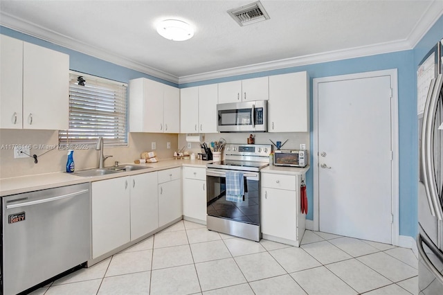 5565 SW 43rd St, Davie, FL 33314 - kitchen with appliances with stainless steel finishes, a sink, crown molding, light countertops, and white cabinetry