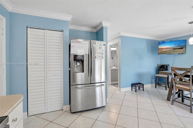 5565 SW 43rd St, Davie, FL 33314 - kitchen with stainless steel fridge with ice dispenser, ornamental molding, baseboards, light tile patterned floors, and a textured ceiling