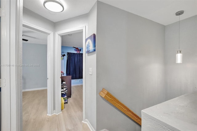 5565 SW 43rd St, Davie, FL 33314 - corridor with light wood-style floors, an upstairs landing, and baseboards