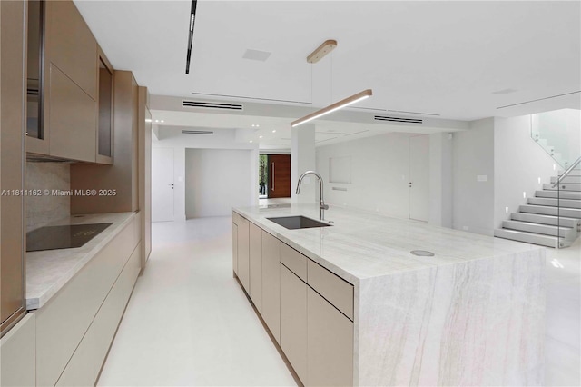 330 SW 19th Rd, Miami, FL 33129 - kitchen featuring black electric stovetop, modern cabinets, a spacious island, open floor plan, and light stone countertops