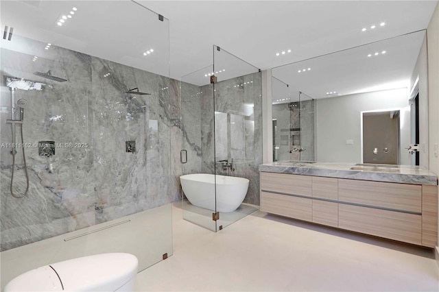 330 SW 19th Rd, Miami, FL 33129 - bathroom featuring vanity, a marble finish shower, tile walls, and a soaking tub