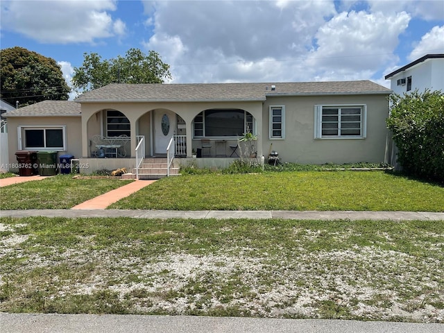 275 W 63rd St, Hialeah, FL 33012 - ranch-style house with a porch, stucco siding, and a front yard