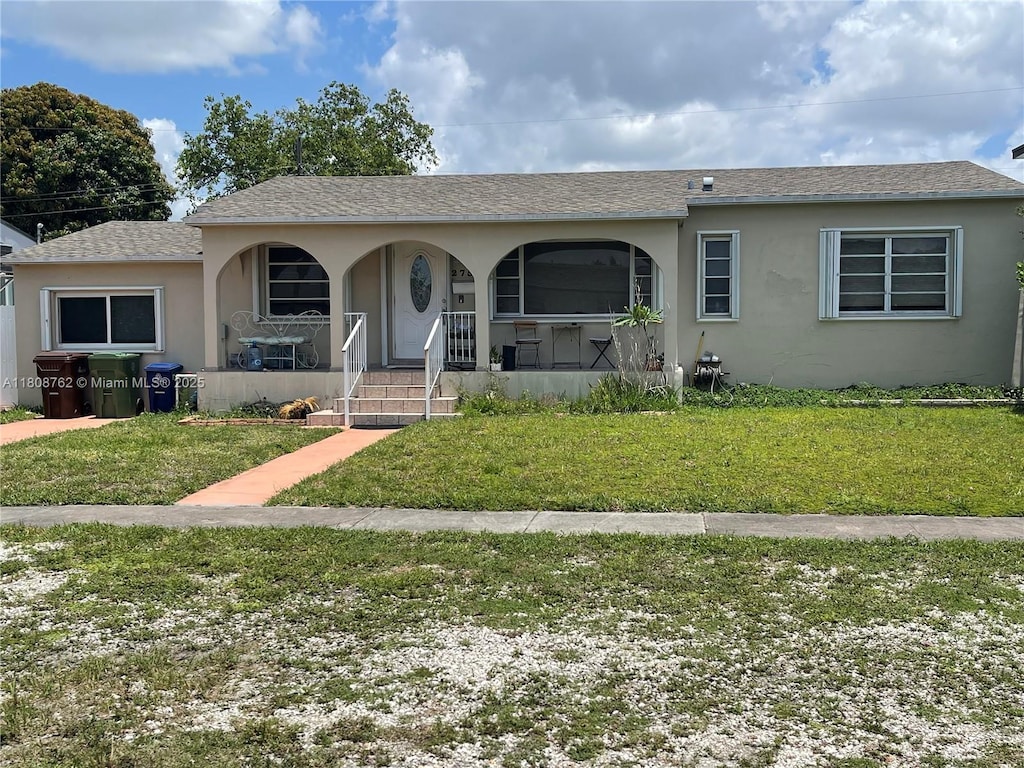 275 W 63rd St, Hialeah, FL 33012 - single story home with stucco siding, covered porch, and a front yard