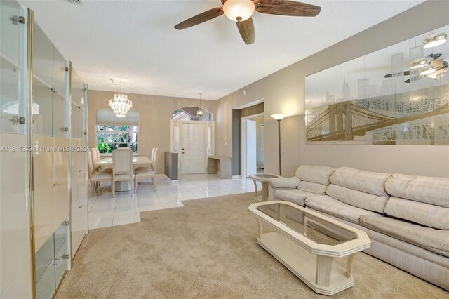 13220 NW 11th Ct, Sunrise, FL 33323 - living area featuring light colored carpet, a ceiling fan, light tile patterned floors, and a chandelier