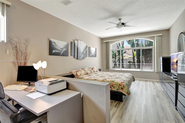 13220 NW 11th Ct, Sunrise, FL 33323 - bedroom with light wood-style floors, a textured ceiling, a desk, and ceiling fan