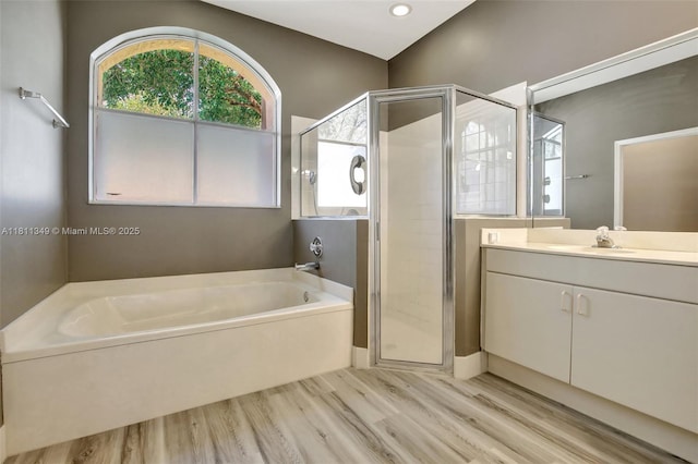 13220 NW 11th Ct, Sunrise, FL 33323 - bathroom with a garden tub, a shower stall, vanity, and wood finished floors