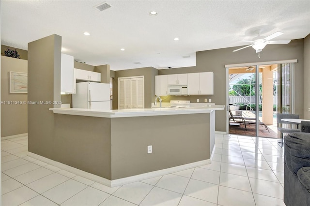 13220 NW 11th Ct, Sunrise, FL 33323 - kitchen featuring white appliances, light countertops, white cabinetry, a ceiling fan, and a peninsula