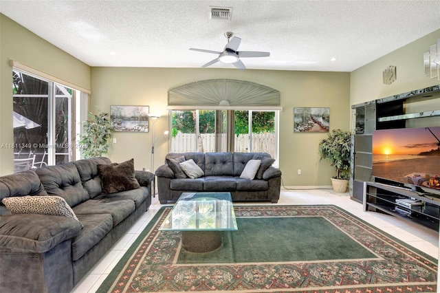 13220 NW 11th Ct, Sunrise, FL 33323 - tiled living area featuring a ceiling fan and a textured ceiling