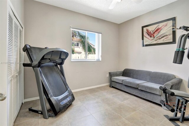 13220 NW 11th Ct, Sunrise, FL 33323 - workout area with light tile patterned floors, a textured ceiling, and a ceiling fan