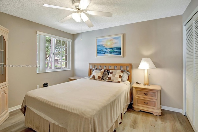 13220 NW 11th Ct, Sunrise, FL 33323 - bedroom featuring light wood-type flooring, a closet, a textured ceiling, and a ceiling fan