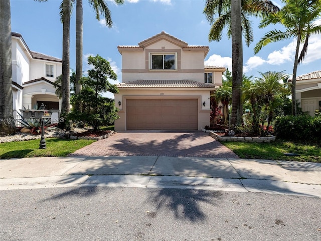 1030 Bamboo Ln, Weston, FL 33327 - mediterranean / spanish-style home featuring stucco siding, decorative driveway, a tiled roof, and an attached garage