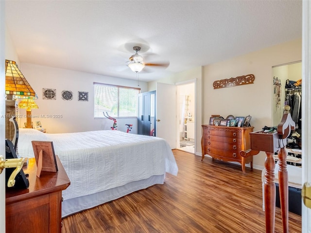 1030 Bamboo Ln, Weston, FL 33327 - bedroom with wood finished floors, a walk in closet, and connected bathroom
