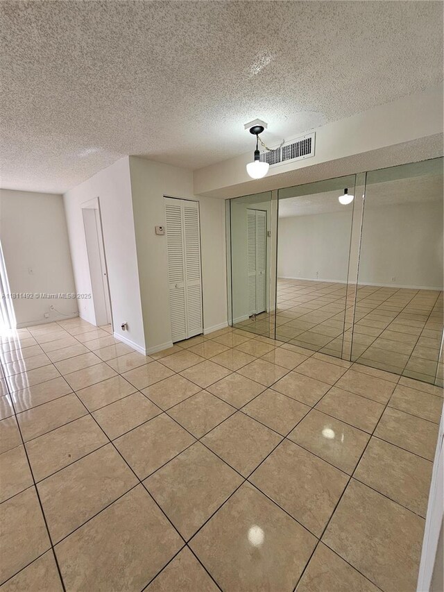 8475 SW 156th Ct Unit 321, Miami, FL 33193 - spare room with tile patterned flooring and a textured ceiling