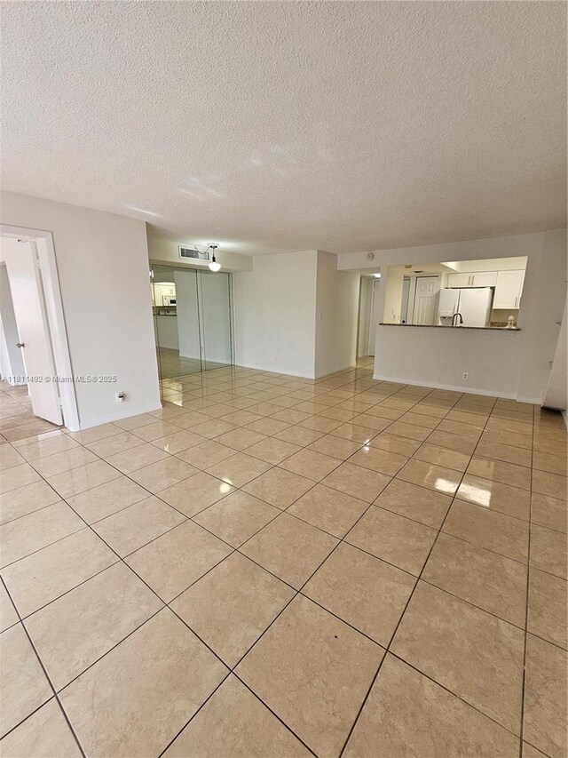 8475 SW 156th Ct Unit 321, Miami, FL 33193 - empty room featuring light tile patterned flooring and a textured ceiling