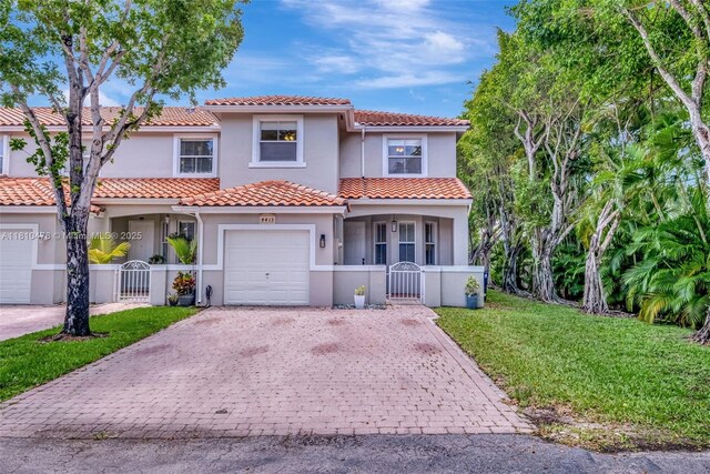 4413 NW 97th Pl, Doral, FL 33178 - mediterranean / spanish house featuring a gate, decorative driveway, and stucco siding