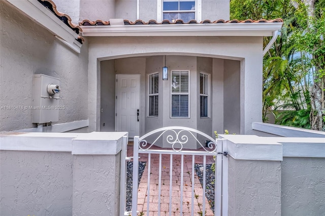 4413 NW 97th Pl, Doral, FL 33178 - doorway to property with a gate, stucco siding, and a tile roof
