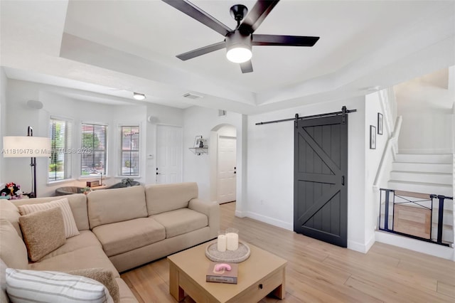4413 NW 97th Pl, Doral, FL 33178 - living room with a raised ceiling, a barn door, ceiling fan, and light wood finished floors