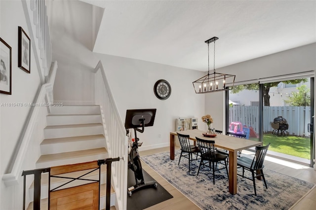 4413 NW 97th Pl, Doral, FL 33178 - dining space featuring stairway, wood finished floors, a chandelier, and baseboards