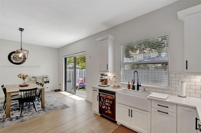 4413 NW 97th Pl, Doral, FL 33178 - kitchen featuring stainless steel appliances, premium range hood, a sink, backsplash, and white cabinets