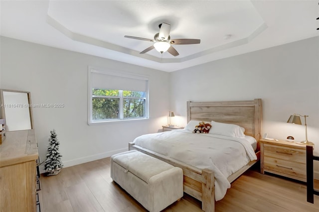 4413 NW 97th Pl, Doral, FL 33178 - bedroom with a tray ceiling, wood finished floors, baseboards, and ceiling fan